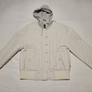 Women's puffer jacket with lightweight hood.